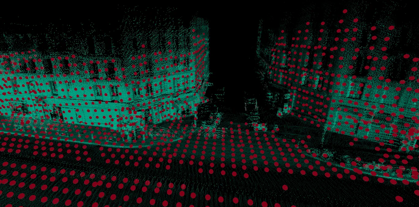 An urban point cloud with regularly sampled red keypoints across buildings and the ground.